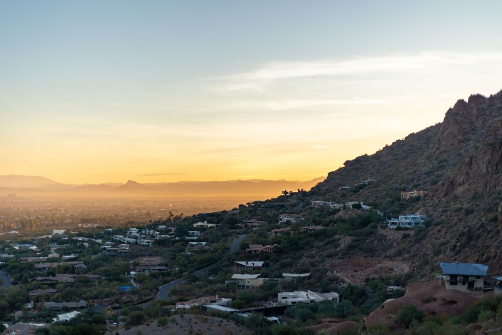 Sunset over the Phoenix valley seen from a hillside of desert homes